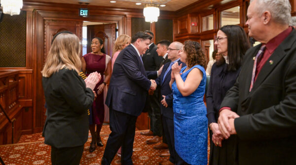 The Illinois House Representative, Jaime Andrade, escorting the Governor, JB. Pritzker, on the IL House floor, Wednesday, Feb. 18 at 11:30 a.m.  (HDS Photo/Cory Hoang)