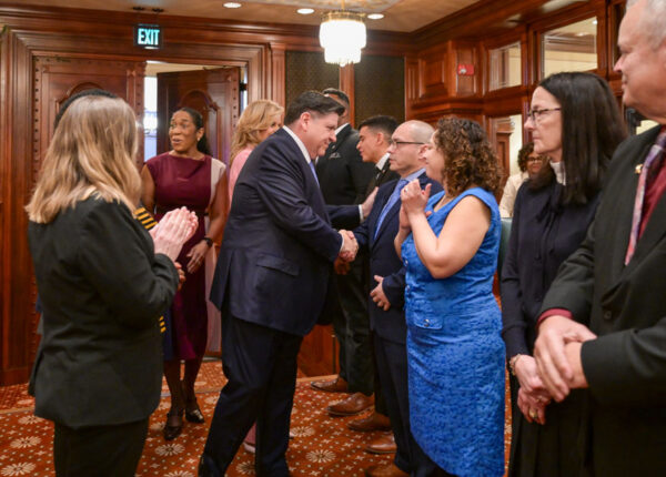 The Illinois House Representative, Jaime Andrade, escorting the Governor, JB. Pritzker, on the IL House floor, Wednesday, Feb. 18 at 11:30 a.m.  (HDS Photo/Cory Hoang)